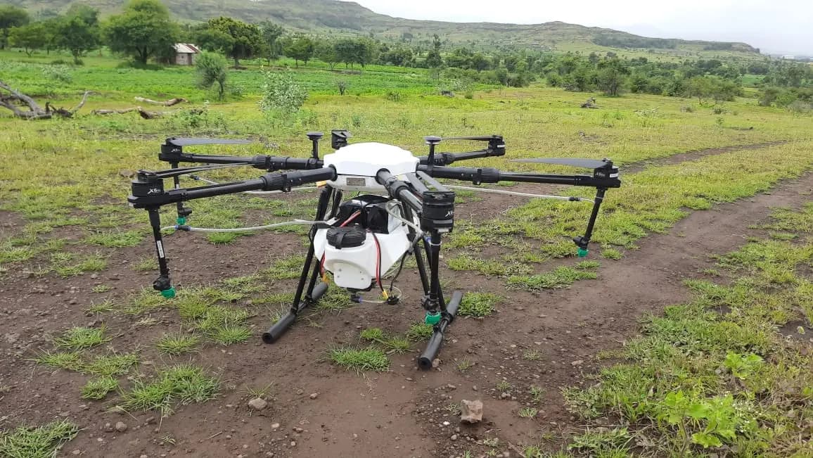 HIMALAYA spraying drone standing on a field track with its rotor arms extended