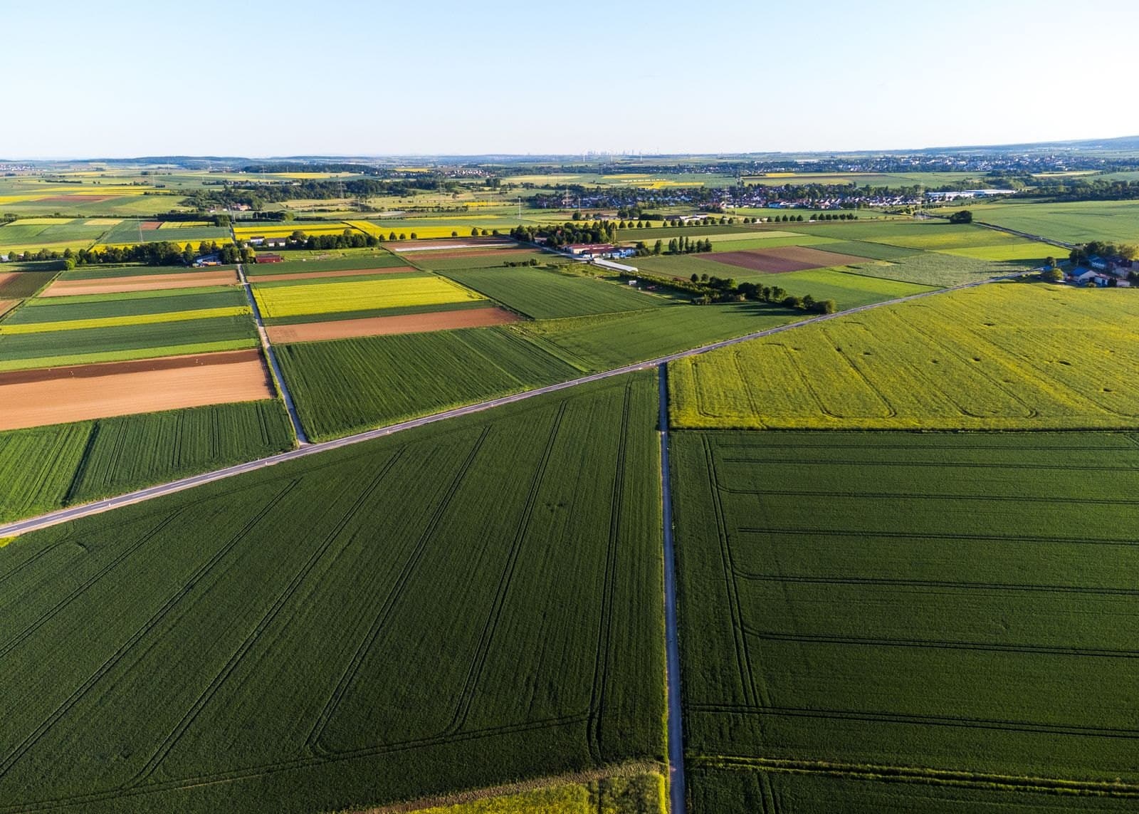 Aerial view of patchwork farmland parcels divided by tracks and field boundaries