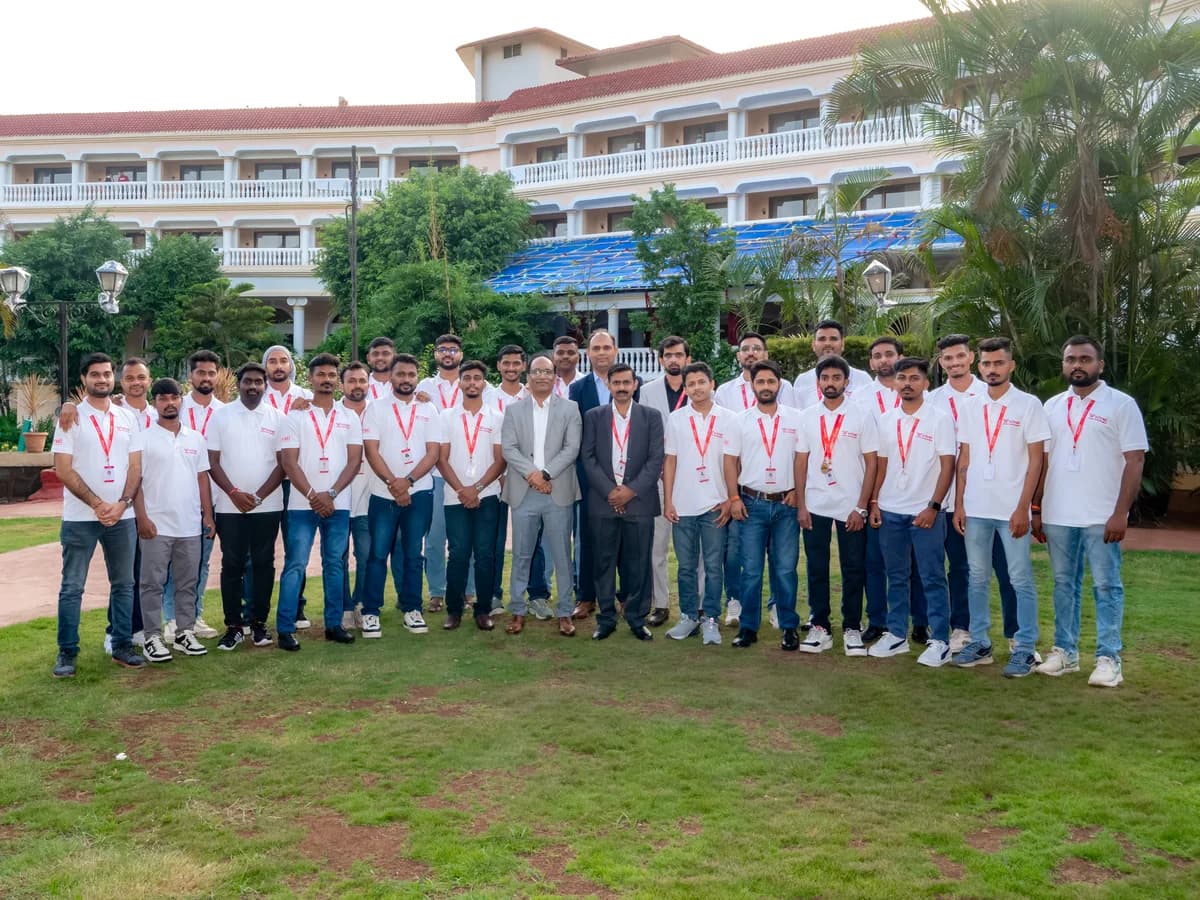 The Schnell Drone Technologies team in company polos, gathered on the lawn for a group photograph