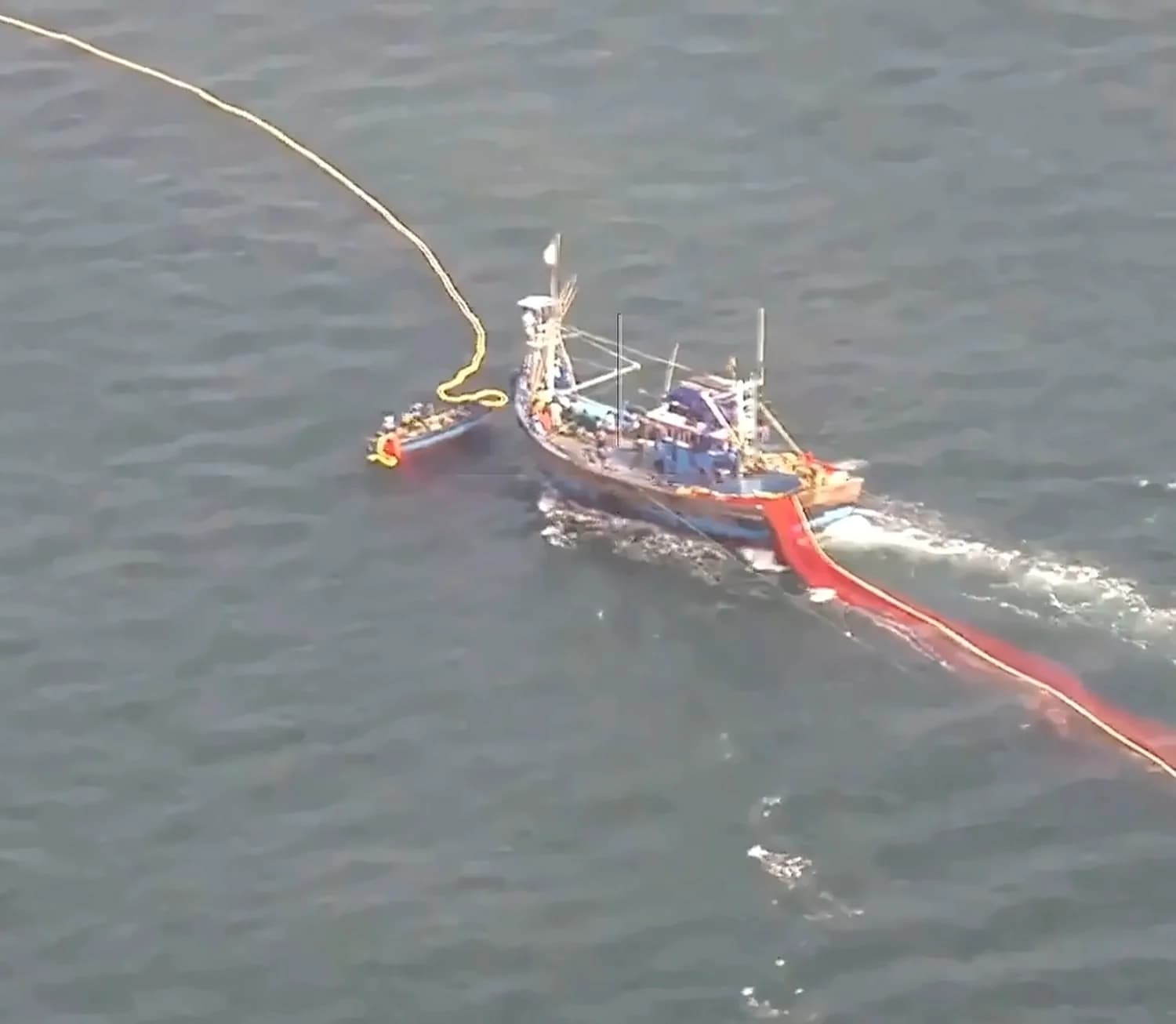 Evidence capture: a fishing vessel under way with its net trailing, recorded with position data