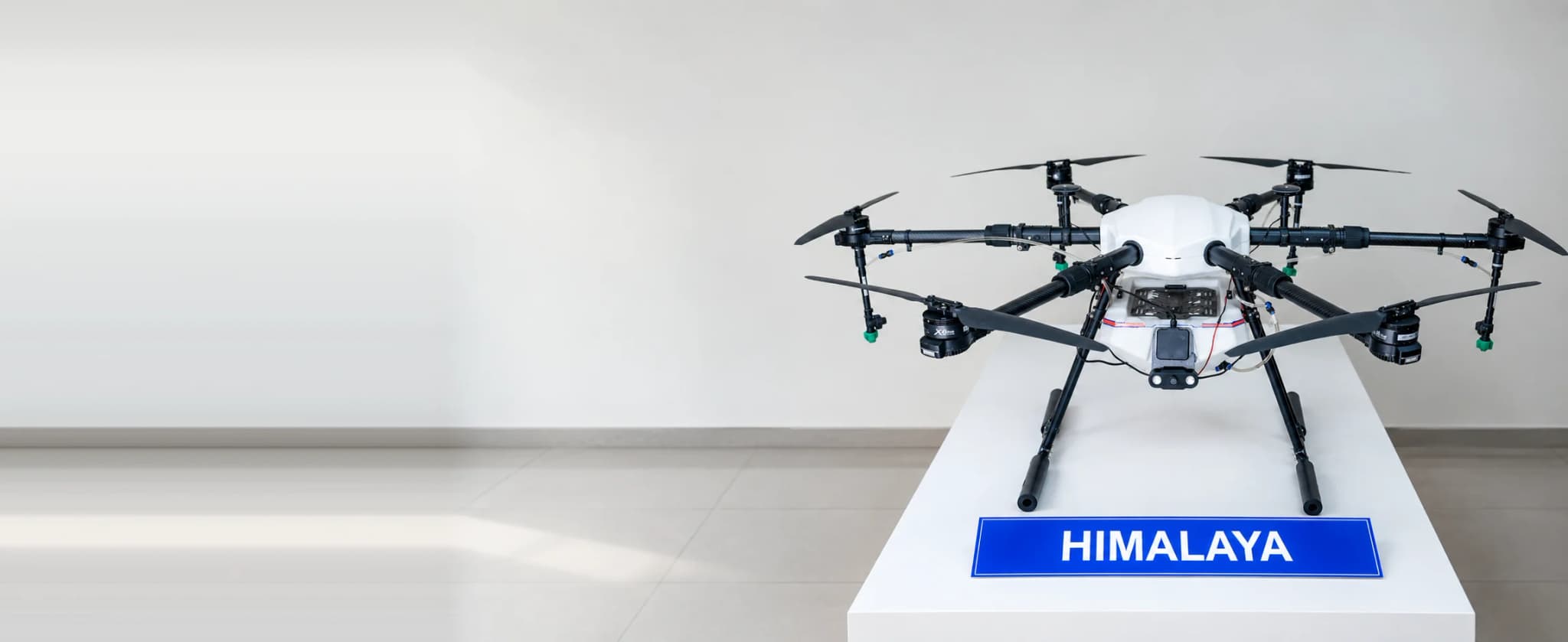 HIMALAYA hexacopter on a white display plinth behind its nameplate, all six rotors extended