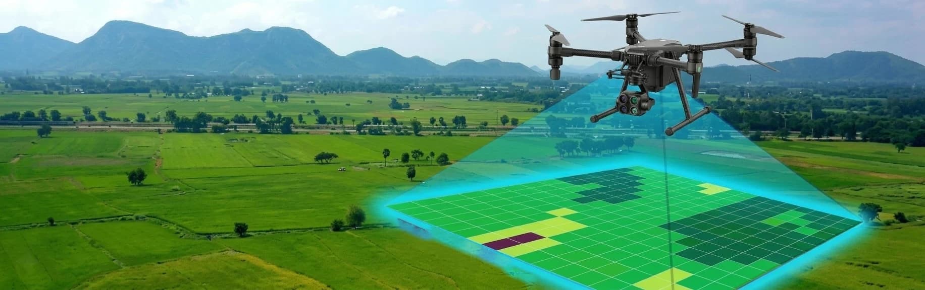 Mapping drone projecting a survey grid over farmland with mountains behind