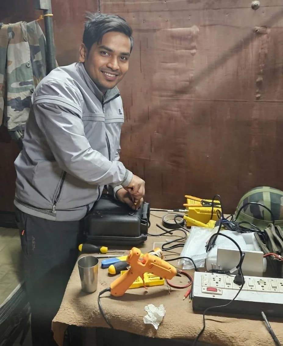 Technician servicing drone equipment with tools laid out on the bench