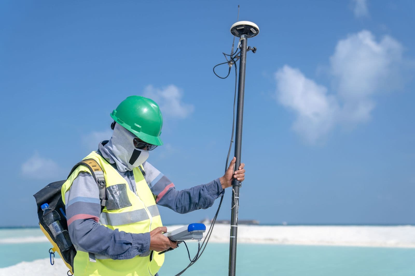 Surveyor taking GPS measurements during a land survey
