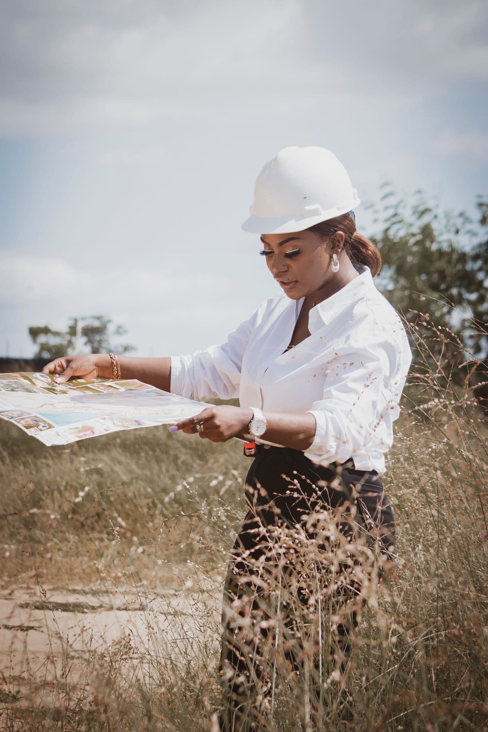 Engineer reviewing technical plans and data in the field